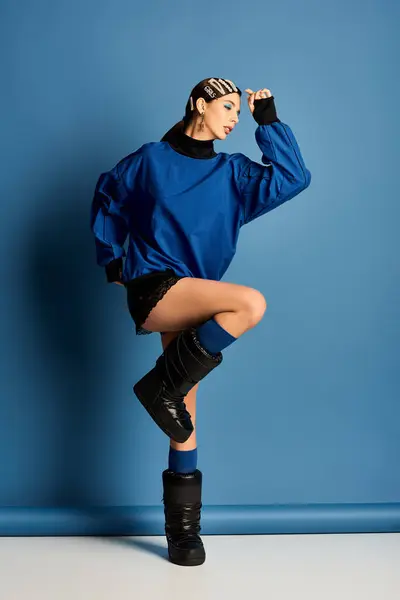 Striking young woman showcases stylish outfit with hair clips while posing elegantly in studio. — Stock Photo