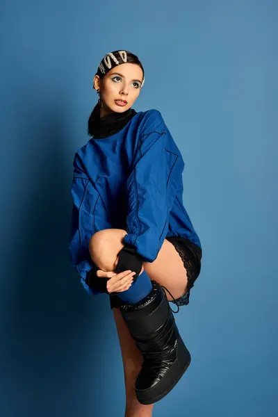 A beautiful young woman showcases her fashion sense with hair clips and stylish attire in a studio. — Stock Photo