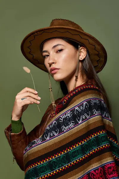 Une jeune brune confiante brille dans une tenue dynamique et traditionnelle, posant gracieusement. — Photo de stock