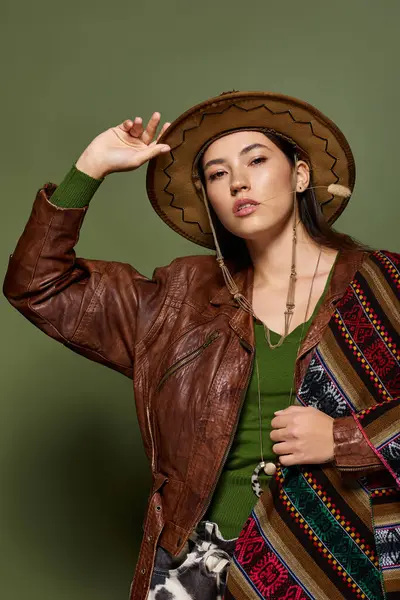 Confident young brunette models a unique outfit, showcasing cultural fashion and style. — Stock Photo