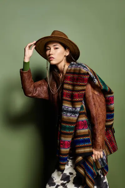 Young brunette sports a colorful shawl and hat in a striking fashion style. — Stock Photo