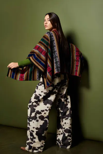A young brunette displays her unique style in colorful clothing with confidence. — Stock Photo