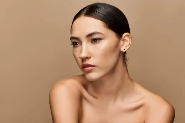 A young brunette woman displays her natural beauty with an elegant expression in a serene setting. — Stock Photo