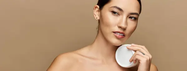 Dans un cadre intérieur calme, une jeune femme brune sublime sa beauté avec des soins de la peau. — Photo de stock