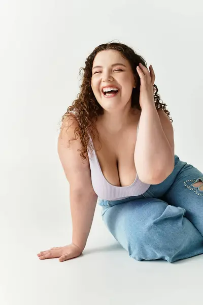 A young woman happily poses in trendy attire while enjoying a lighthearted moment indoors. — Stock Photo