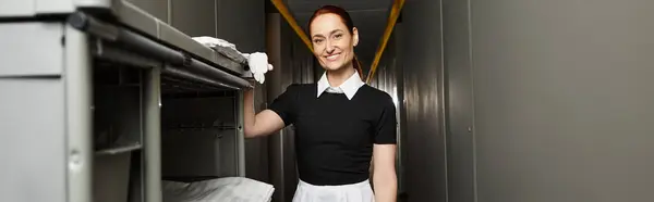 Bright smile on a young woman as she tidies up a storage area, radiating positivity and warmth. — Stock Photo