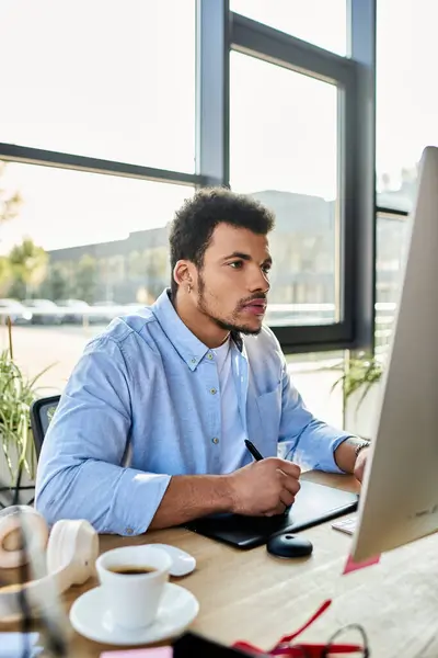 Handsome man focuses on his work while enjoying a refreshing cup of coffee. — Stock Photo