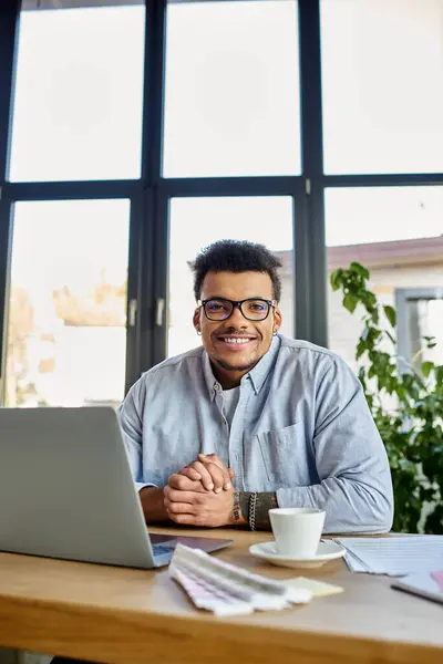 A cheerful man engages in his work from a bright home office, radiating positivity and focus. — Stock Photo