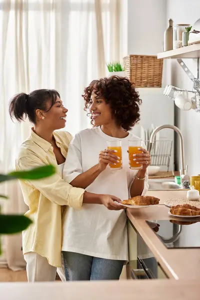 Two young women share a happy breakfast, enjoying each others company in the morning light. — Stock Photo