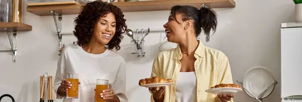 Two women share laughter and joy over breakfast in a stylish morning setting, banner — Stock Photo