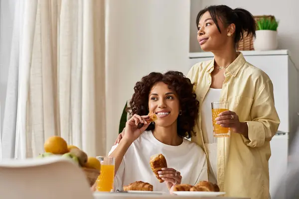 Jeune couple prenant le petit déjeuner ensemble dans un appartement lumineux et moderne pendant les heures du matin. — Photo de stock