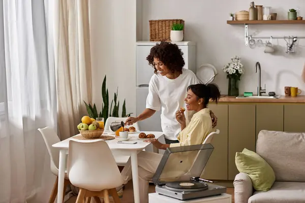 A young African American couple shares a warm breakfast together, enjoying each others company. — Stock Photo