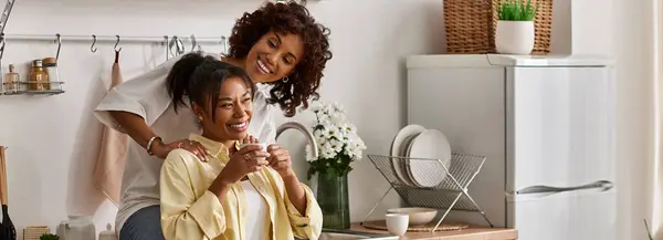 A happy couple enjoys coffee and laughter in their stylish apartment, embracing their love, banner — Stock Photo