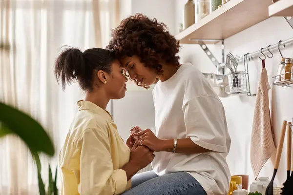 Two young women warmly connect in their stylish apartment during a cozy afternoon together. — Stock Photo