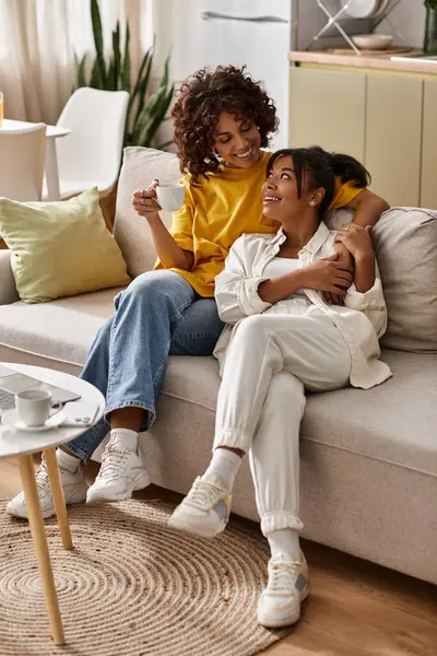 A happy young Black couple enjoys love and laughter in their stylish modern apartment. — Stock Photo