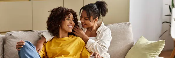 A young Black lesbian couple relaxes together in their chic home, enjoying each others company, banner — Stock Photo