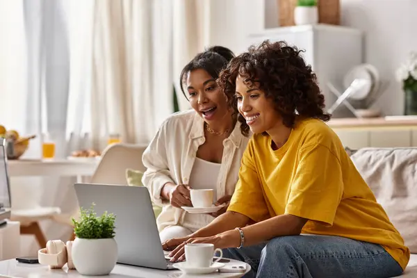 Two young african american women are happily working together in their stylish home office space. — Stock Photo