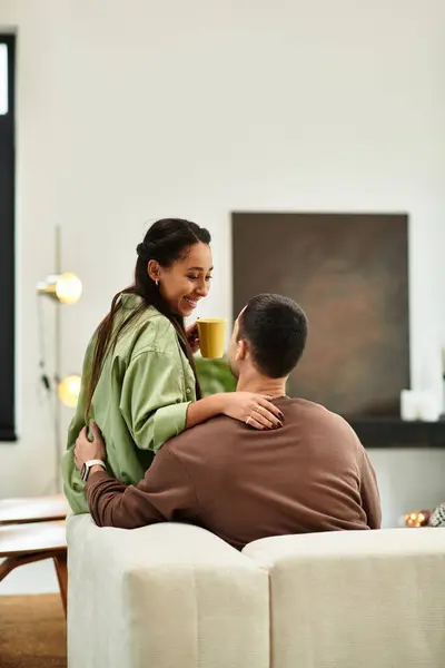 Loving couple shares warm laughter and comfort in their modern apartment — Stock Photo
