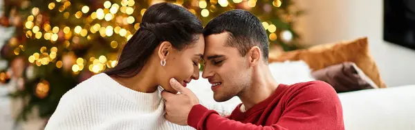 Couple enjoys a cozy moment together in their modern apartment, celebrating the holiday season, banner — Stock Photo