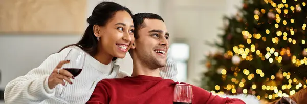 A happy couple enjoys each other's company with wine in their beautifully decorated living room, banner — Stock Photo