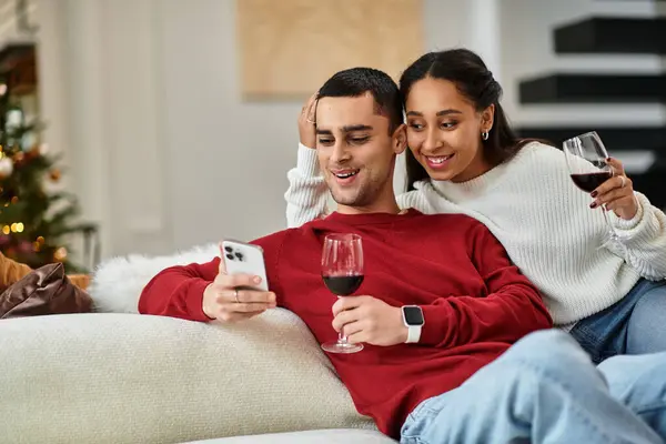 A happy couple relaxes at home with wine during the holidays. — Stock Photo