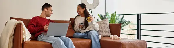 Un beau couple profite d'un moment de qualité sur un canapé, enveloppé dans une tenue d'hiver confortable, bannière — Photo de stock