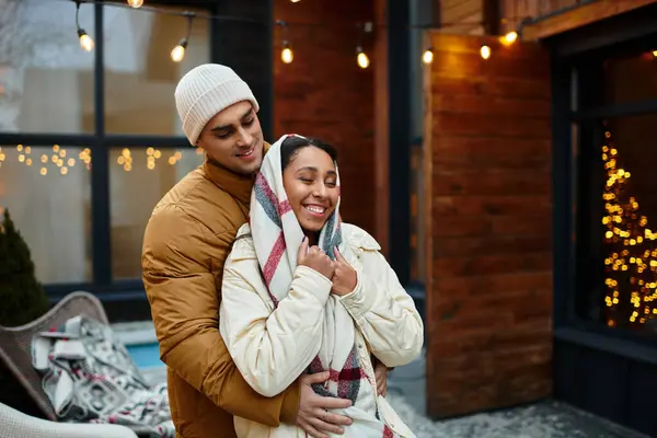 A beautiful couple shares warmth and joy outdoors, enjoying winter holiday magic together. — Stock Photo