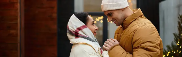 A beautiful couple enjoys a tender moment outdoors surrounded by festive lights, banner — Stock Photo