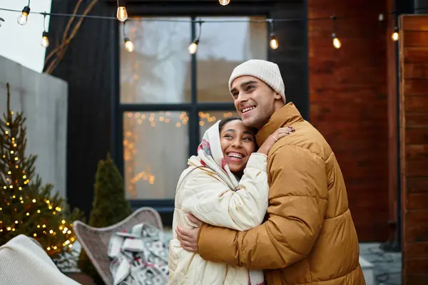 A lovely couple shares warm moments together amid festive decorations. — Stock Photo