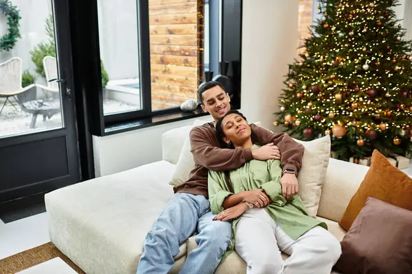 A happy couple enjoys each others company in their stylish apartment filled with holiday cheer. — Stock Photo