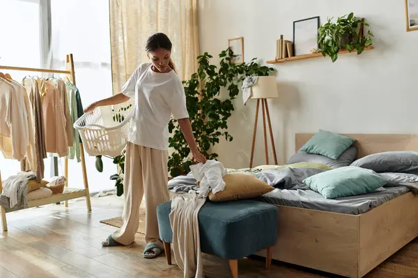 A young African American woman organizes her living space in a stylish apartment, managing chores. — Stock Photo