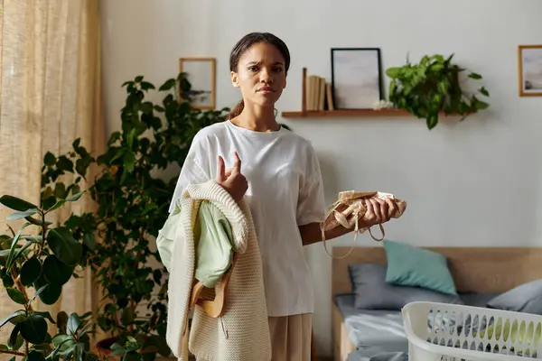 A young African American woman organising her home — Stock Photo