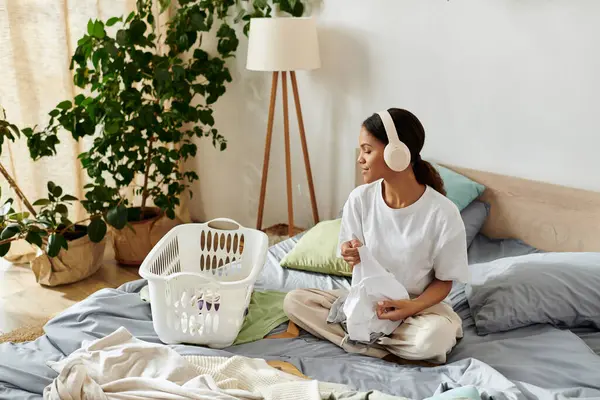 Bright and airy apartment features a young woman happily doing her housekeeping chores with care. — Stock Photo