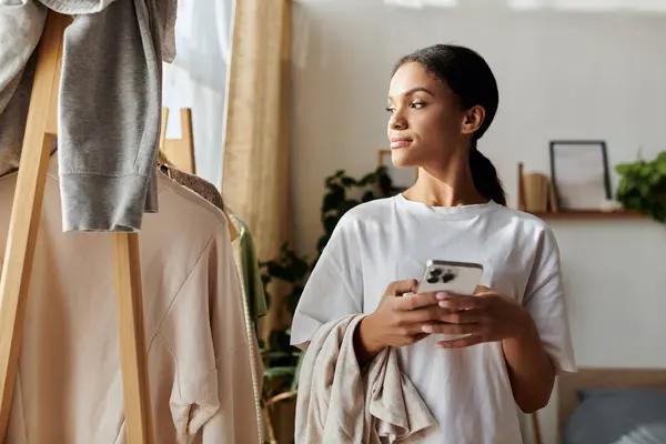 A young African American woman focuses on her cleaning tasks in a stylish apartment. — Stock Photo