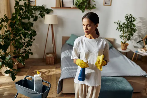A young African American woman thoroughly cleans her tidy modern apartment while enjoying the task. — Stock Photo