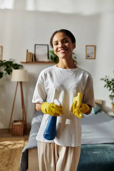 A cheerful young woman cleans her modern apartment, embracing daily chores with joy. — Stock Photo
