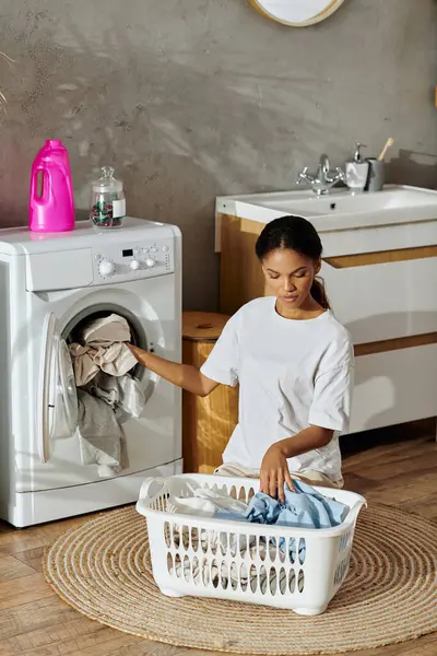 A young African American woman works on her house cleaning tasks, creating a tidy home. - foto de stock