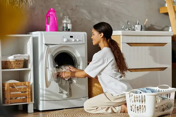In a stylish modern apartment, a young woman engages in her cleaning routine, focusing on laundry. — Stock Photo