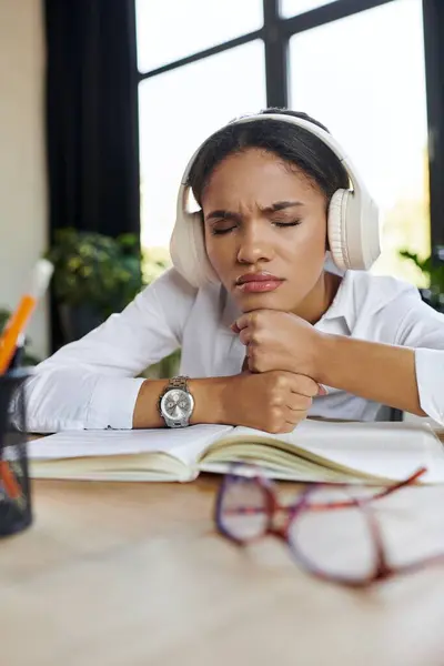 Young professional wearing headphones in a stylish workspace, listening music — Stock Photo