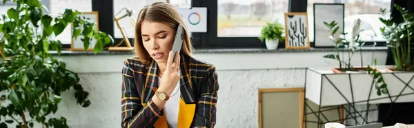 Attractive young businesswoman engaged in a phone conversation while working in a modern office, banner — Stock Photo