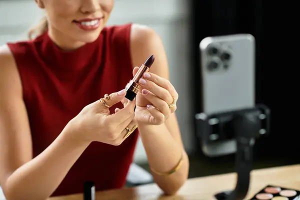 Attractive millennial influencer shares beauty tips while showcasing her favorite lipstick online. — Stock Photo
