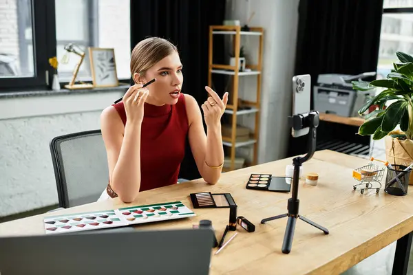 Attractive young woman streams makeup tutorials through her smartphone in a stylish workspace. — Stock Photo