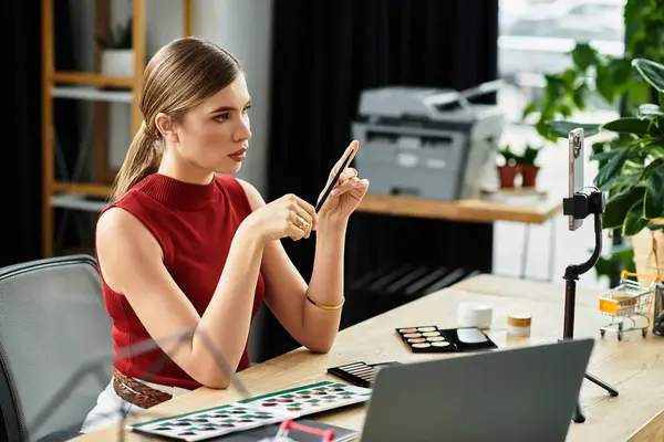 Attractive young woman shares makeup tips while streaming from her stylish workspace. — Stock Photo