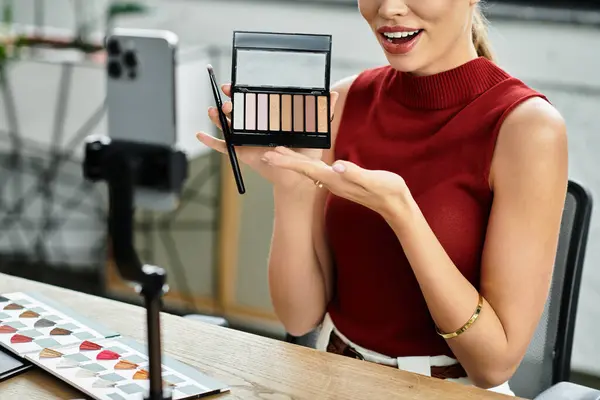 Attractive young woman shares beauty product secrets while streaming online from her workspace. — Stock Photo