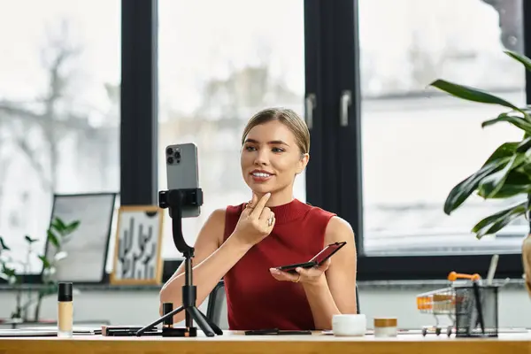 A young woman showcases beauty products live on her smartphone, captivating her audience. — Stock Photo