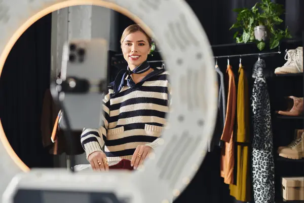 Young stylist showcases her latest fashion looks while recording on her smartphone. — Stock Photo