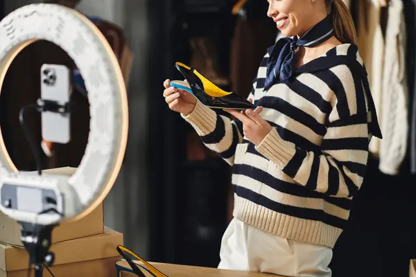 Young woman showcases stylish footwear and outfits while filming content for her followers. — Stock Photo