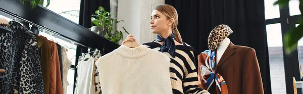 A young woman skillfully creates a fashionable outfit selection while recording her process, banner — Stock Photo