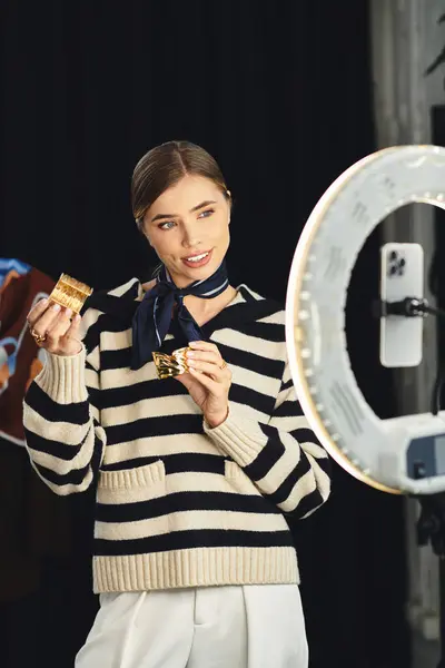 Attractive woman showcases her outfit, sharing style tips through her smartphone recorded content. — Stock Photo