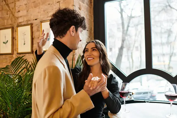 A couple celebrates their love with laughter and dance while dining at a romantic restaurant. — Stock Photo